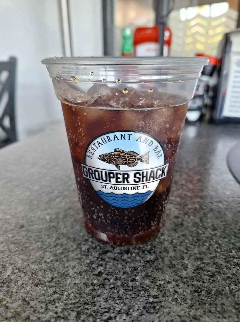 Grouper Shack branded cup with iced drink showing Restaurant and Bar logo, St. Augustine Florida
