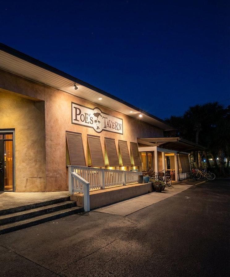 Poe's Tavern entrance and covered outdoor dining patio at night, Atlantic Beach Florida
